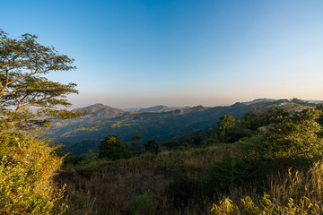 beautiful blue sky high peak mountains mist fog wildlife green forest at Khao Koh Phu Tub Berk Phetchabun Thailand guiding idea long weekend for backpacker camping campfire relaxing hiking  