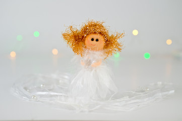 Christmas angel with a star in his hands, delicate and beautiful on a light background
