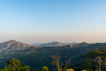 Fototapeta premium beautiful blue sky high peak mountains mist fog wildlife green forest at Khao Koh Phu Tub Berk Phetchabun Thailand guiding idea long weekend for backpacker camping campfire relaxing hiking 