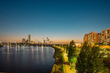 Fototapeta premium Cityscape with sky scrappers after sunset. 