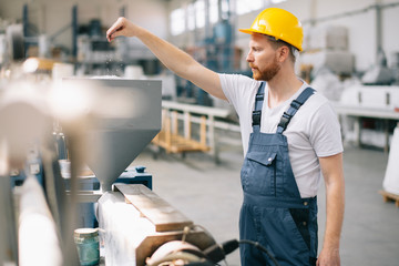 Factory worker. Man with helmet working.