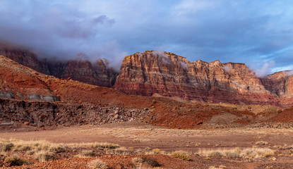 Towering Red Rock Cliffs In Northern Arizona with Clouds