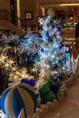 Christmas tree, gift boxes, lanterns and Christmas balls in Christmas 