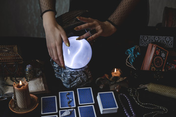 Tarot cards and crystal ball, candles, witch magic bottles . Wicca, esoteric, divination and occult...