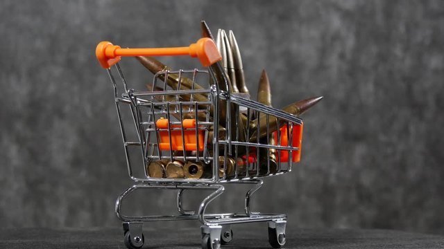 caddy for shopping with ammunition, concept of money for war