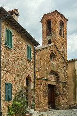 Fototapeta na wymiar stone, medieval church with belfry of the city of Pereta in Tuscany.