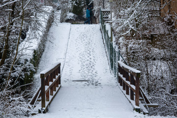 A small bridge in a German village in Bavaria after snow