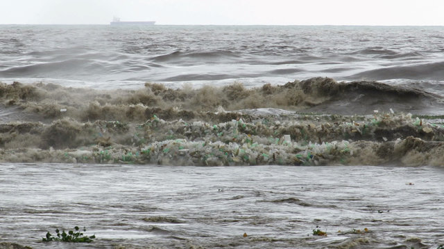 Still image of trash following waves at sea in Durban