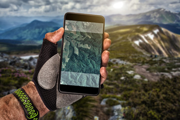Smartphone GPS navigator in man's hand.