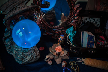 Tarot cards and crystal ball, candles, witch magic bottles . Wicca, esoteric, divination and occult background with vintage magic objects for mystic rituals