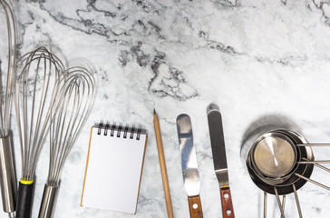 Cooking tools concept on marble tabletop. Measuring ingredients by follow recipe proportion with...