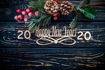 Happy new year 2020 on wooden brown background.