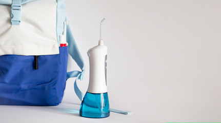 Portable electronic oral irrigator as a part of oral hygiene travel kit
