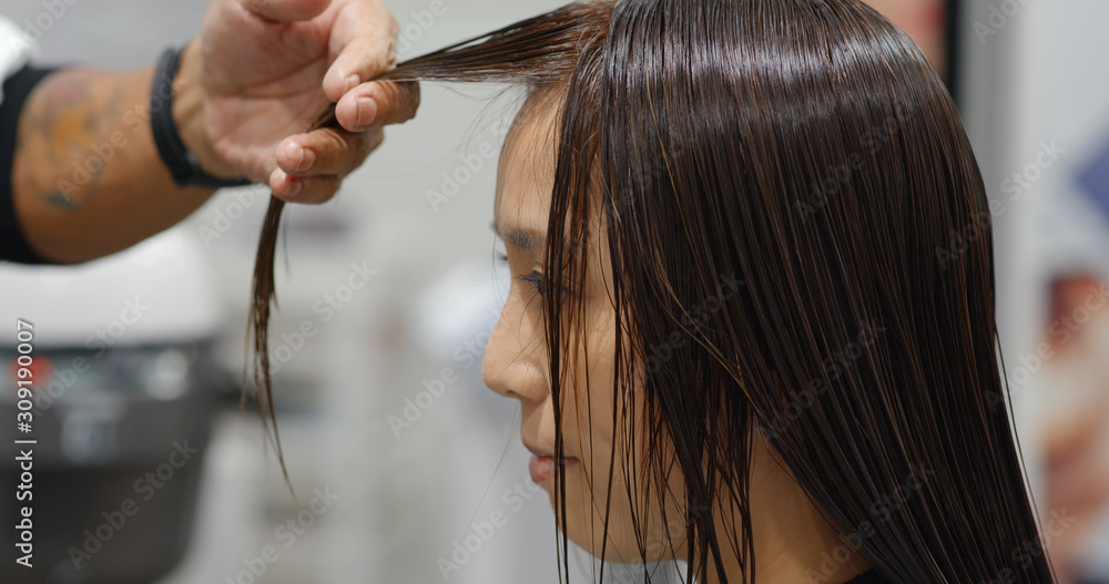 Wall mural Woman with hair cut at beauty salon