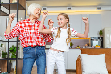 Girl giving her grandparent a dance lesson
