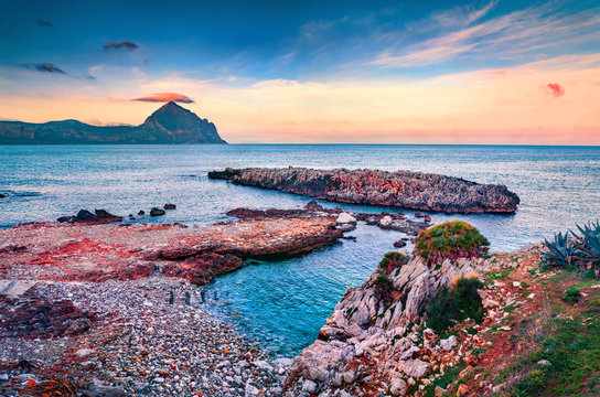Attractive morning view of Isolidda beach. Colorful spring sunrise in Sicily, Macari village, San Vito cape, Province of Trapani, Italy, Europe. Gorgeous seascape of Mediterranean sea.