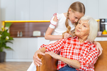 Pretty girl bending over a senior lady