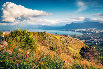 Sunny morning view of Bagheria town and national park Orientata Pizzo Cane, Pizzo Trigna e Grotta Mazzamuto. Picturesque summer scene of Sicily, Italy. Bright seascape of Mediterranean sea.