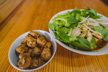 Chicken noodles soup in bowl at noodle shop street .	