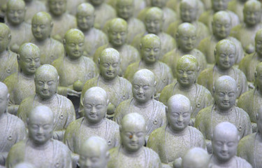 many small standing stone buddha statues