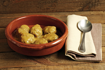 Casserole of meat balls in sauce on wood