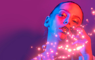  Fashion model metallic silver lips and face woman in neon uv blue and   purple lights, posing in studio, beautiful girl, glowing make-up,   colorful make up. 
