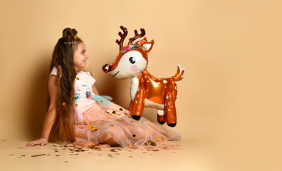 Cute girl with a deer in the studio