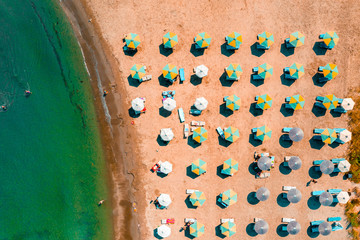 Fototapeta na wymiar View of umbrellas and people relaxing and bathing at Alaminos beach. Larnaca District, Cyprus