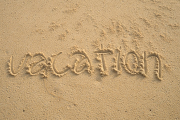 Vacation word on sand;vacation time concept
