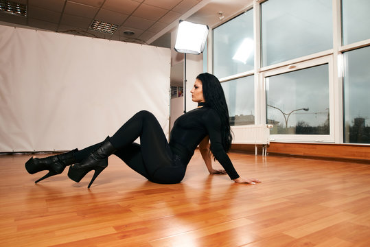 Attractive girl with a good figure dancing strip-plastic in the dance class. Strip-dance. Frame up strip. Sport.
