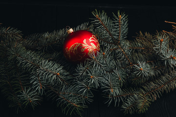 Christmas New Year decoration composition. Top view of fur-tree branches and balls frame on wooden background with place for your text. close up.