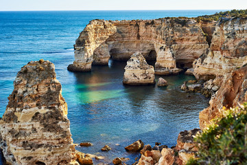 Rocks and sandy beach in Portugal, Atlantic coast, Algarve.