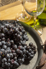 Red wine grape in dark metal tray.
