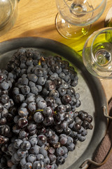 Red wine grape in dark metal tray.