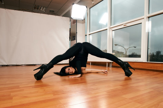Attractive girl with a good figure dancing strip-plastic in the dance class. Strip-dance. Frame up strip. Sport.