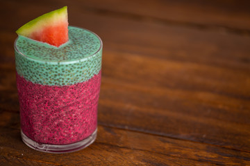 Glass of black chia pudding with watermelon taste