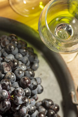 Red wine grape in dark metal tray.