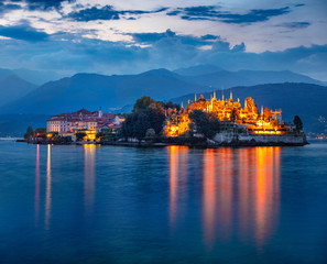 Fantastic evening cityscape of Stresa town. Splendid summer night on Maggiore lake with Bella island on background, Province of Verbano-Cusio-Ossola, Italy, Europe. Traveling concept background.