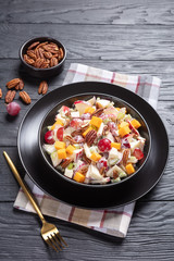 modern apple salad with pecan nuts, close-up