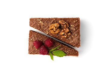 Slice of chocolate cake with raspberry and walnut isolated on white background.