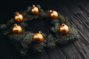 Fototapeta na wymiar Colored christmas decorations on black wooden table. Xmas balls on wooden background. Top view, copy space. new year.