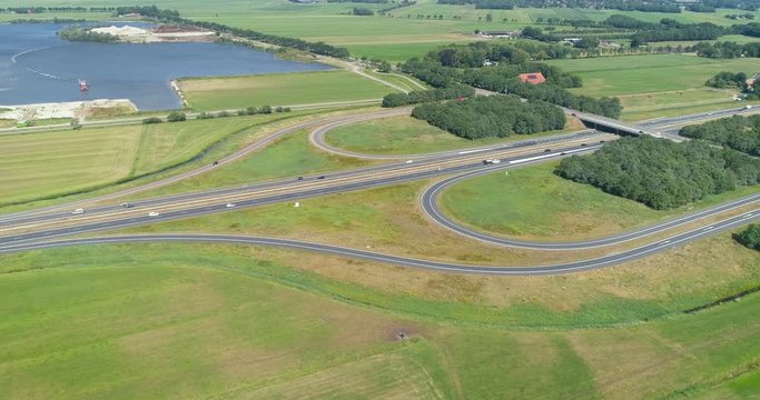 Slow Moving Shot of the A7 Highway on a Sunny Day, Exit 28, Near Drachten and Beetsterzwaag, Traffic consists of Cars and Trailers, Friesland, Netherlands / Holland &ndash; 4K Drone Footage
