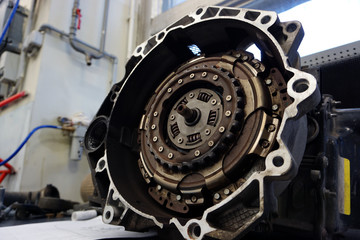 The DSG automatic gearbox lies on the desktop prepared to replace the clutch kit. Service, repair, spare parts for a modern car. Modern technologies in the manufacture and repair of a car. Workshop.