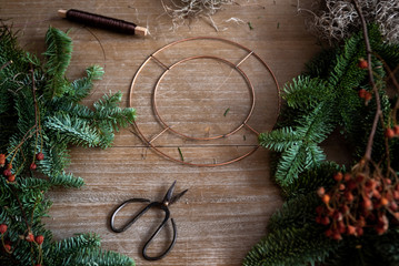 Making Christmas wreath of spruce, step by step. Concept of florist's work before the Christmas...