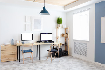 Beautiful cozy modern bright interior furniture made of natural materials and a workplace with two computers and monitors with a white screen. Home goods concept. Advertising space