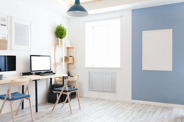 Beautiful cozy modern bright interior furniture made of natural materials and a workplace with two computers and monitors with a white screen. Home goods concept. Advertising space