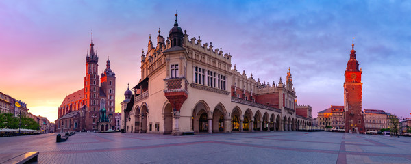 Panorama of Medieval Main market square with Basilica of Saint Mary, Cloth Hall and Town Hall Tower in Old Town of Krakow at sunrise, Poland