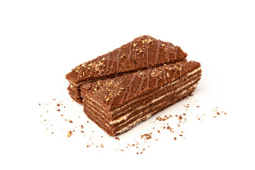 Slice of chocolate cake with milk filling and chocolate isolated on white background.