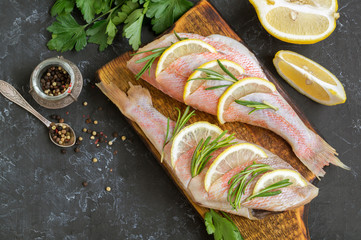 red sea bass fish on black background.