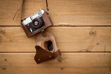 Retro camera hanging on wood wall